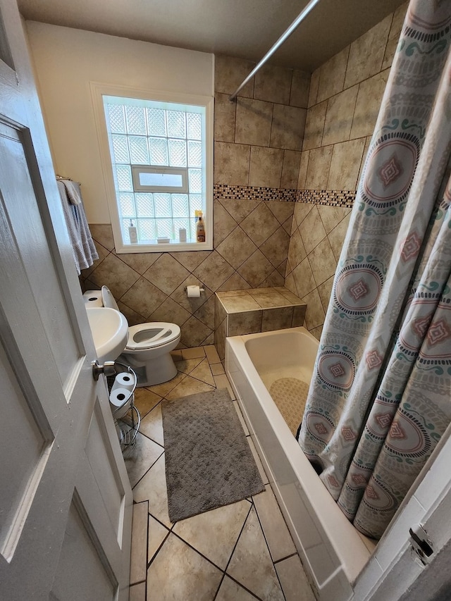 bathroom featuring sink, tile patterned flooring, tile walls, and toilet