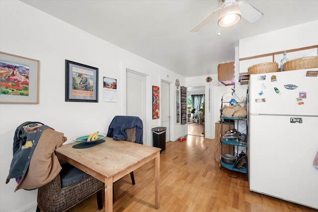 dining space featuring light wood-type flooring and ceiling fan