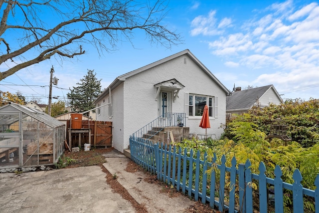 bungalow-style house featuring an outbuilding