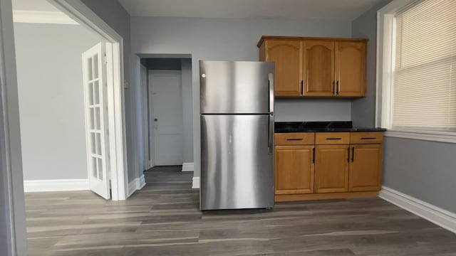 kitchen with dark hardwood / wood-style floors and stainless steel refrigerator