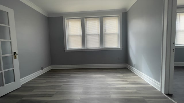 spare room featuring crown molding and wood-type flooring