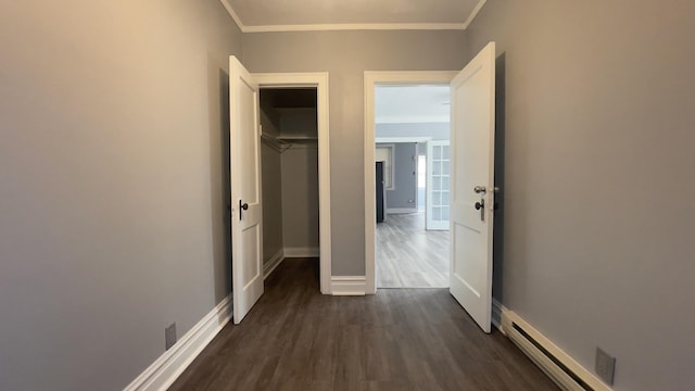 hallway with crown molding, dark hardwood / wood-style flooring, and baseboard heating