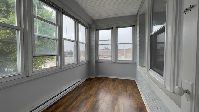 unfurnished sunroom with a baseboard heating unit