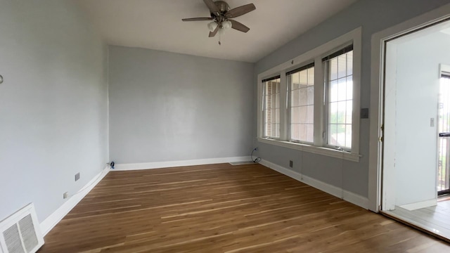 empty room featuring ceiling fan and dark hardwood / wood-style flooring