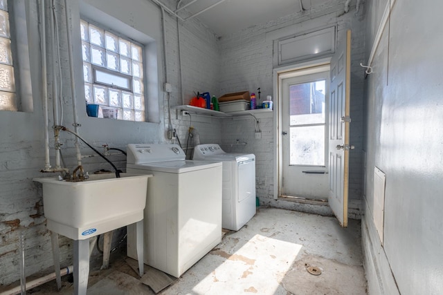 clothes washing area with washer and dryer