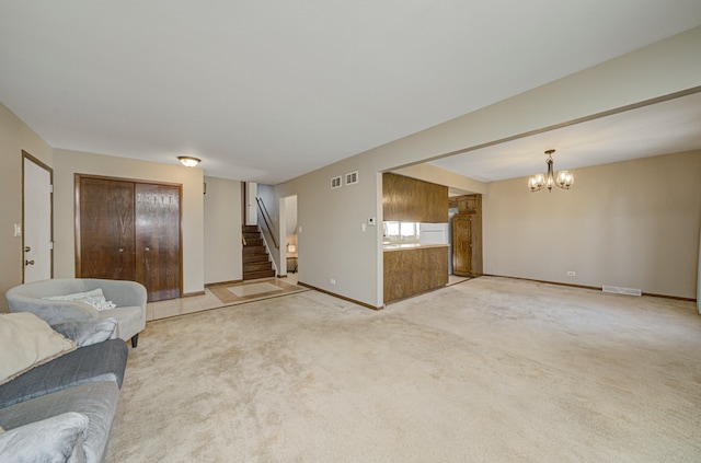 unfurnished living room featuring a chandelier and light colored carpet