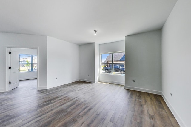 empty room with wood-type flooring and a wealth of natural light