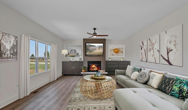 living room featuring wood-type flooring and ceiling fan