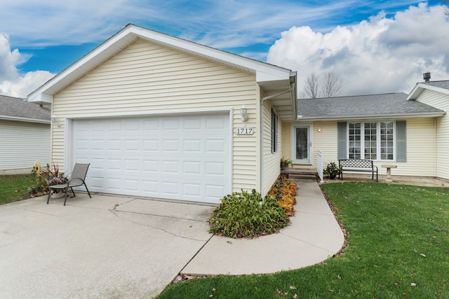 ranch-style house featuring a garage and a front lawn