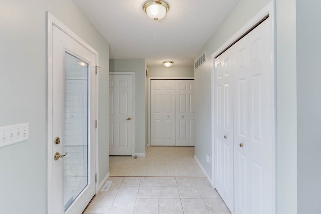 hallway with light tile patterned floors