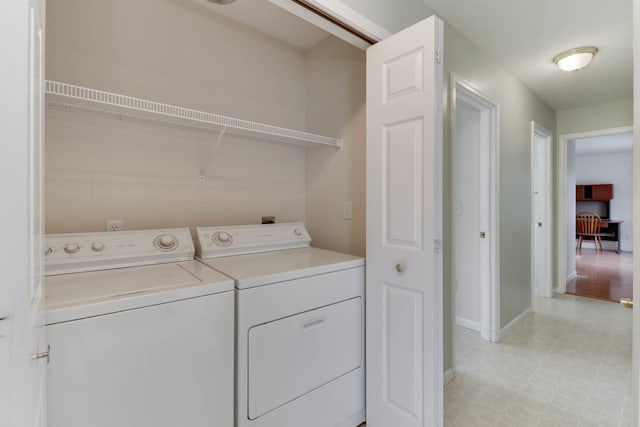 clothes washing area featuring washer and clothes dryer