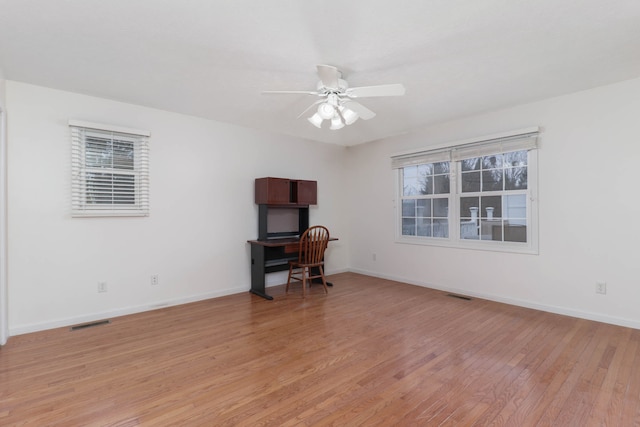 unfurnished office with ceiling fan and light hardwood / wood-style flooring