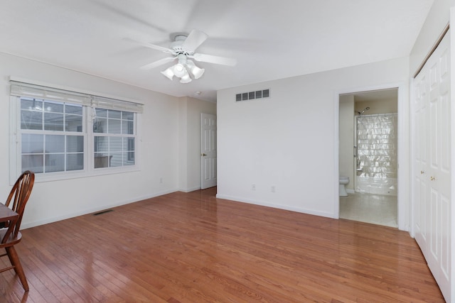 empty room featuring ceiling fan and hardwood / wood-style floors