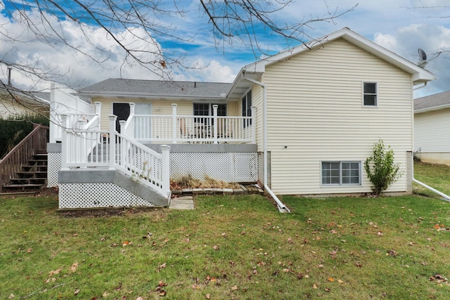 back of property featuring a lawn and a deck