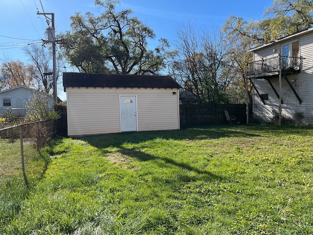 view of yard with a balcony and a shed