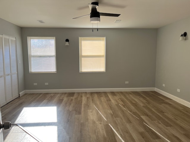 spare room with hardwood / wood-style flooring and ceiling fan