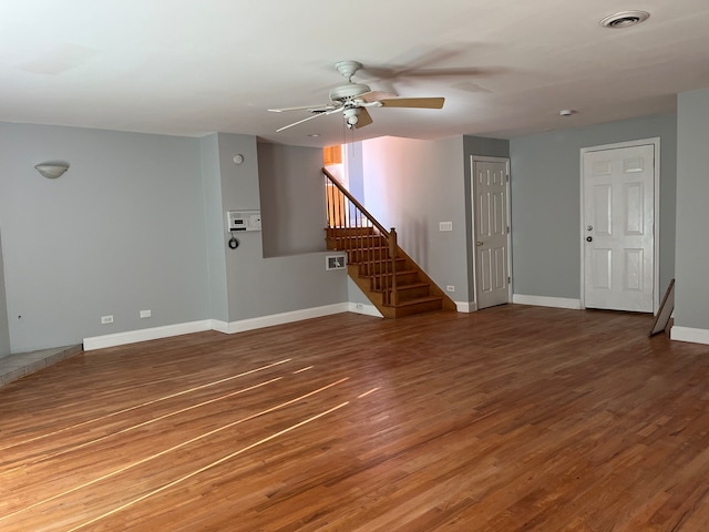 unfurnished living room with ceiling fan and wood-type flooring