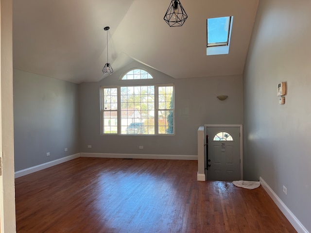 entrance foyer with dark hardwood / wood-style flooring and vaulted ceiling with skylight