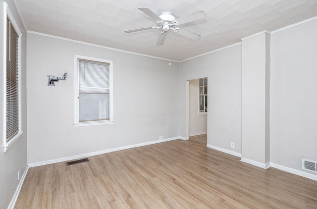 spare room featuring ceiling fan, light wood-type flooring, and crown molding