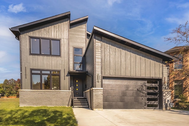 contemporary house with a garage and a front lawn