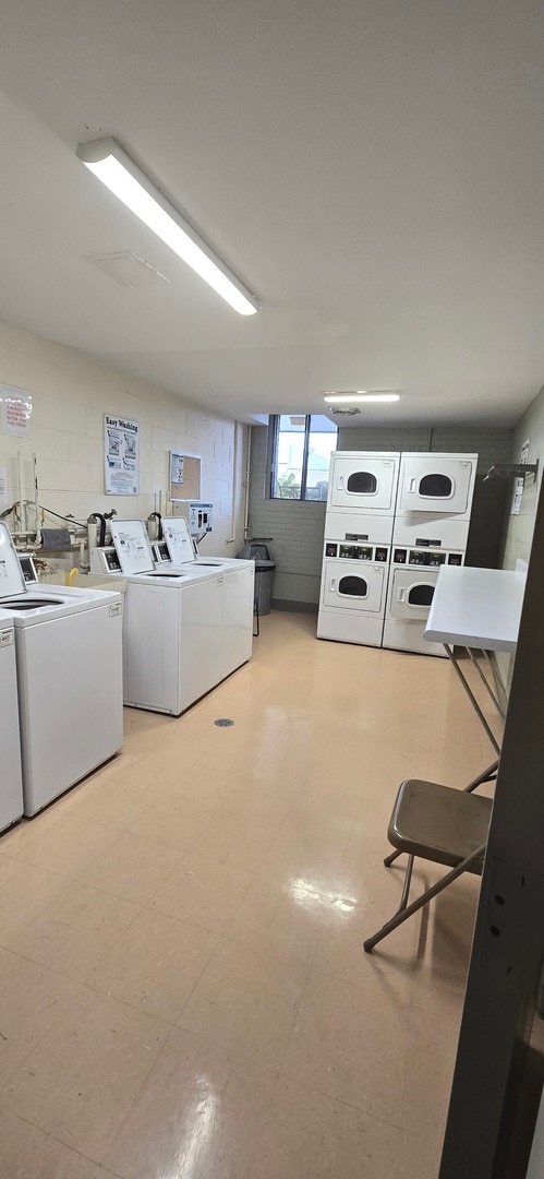 laundry area with washer and clothes dryer and stacked washer and clothes dryer