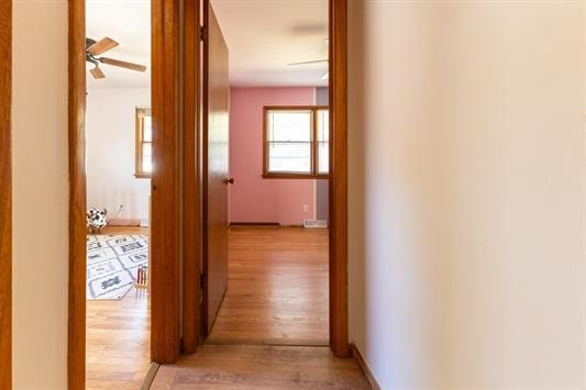 corridor with light hardwood / wood-style flooring