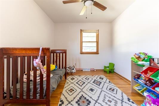 bedroom featuring wood-type flooring and ceiling fan