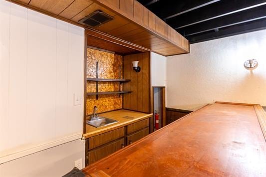 bar with sink and wood ceiling