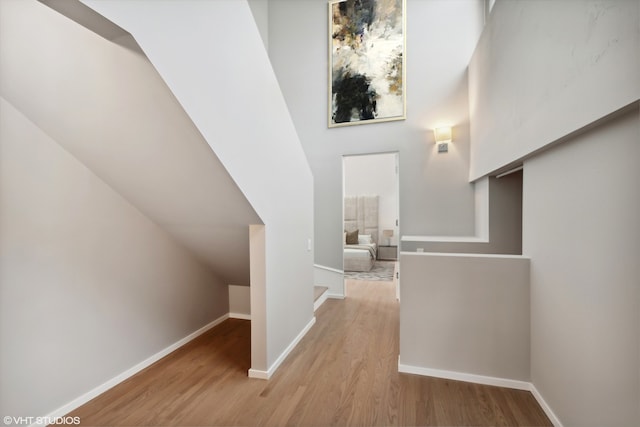 corridor with light hardwood / wood-style floors