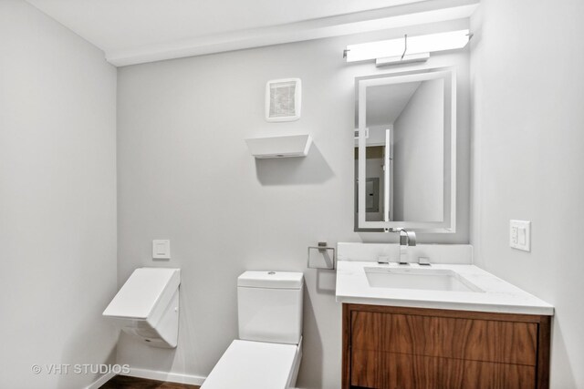 bathroom featuring vanity and toilet