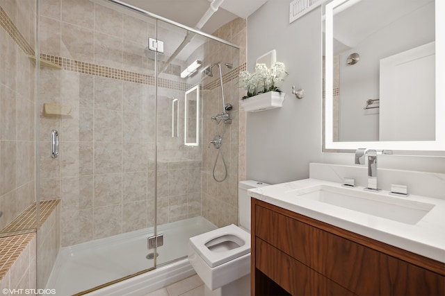 bathroom featuring vanity, toilet, and an enclosed shower