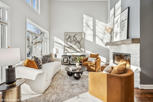 living room featuring a stone fireplace