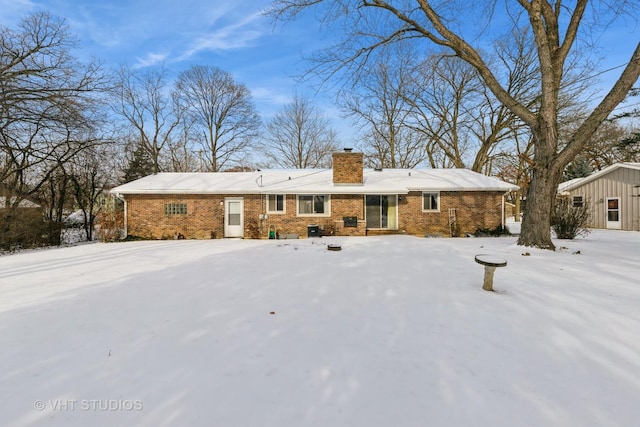 view of snow covered rear of property