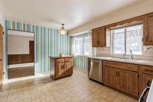 kitchen with dishwasher, pendant lighting, plenty of natural light, and sink