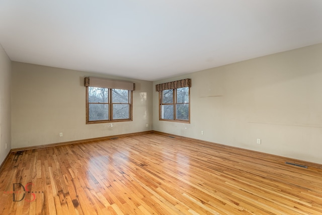 spare room with light hardwood / wood-style flooring