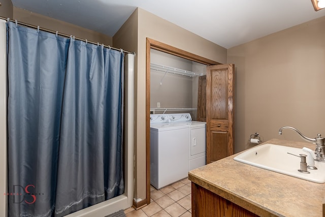 bathroom with vanity, tile patterned floors, and washing machine and clothes dryer