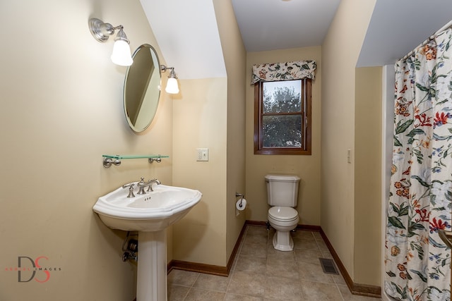 bathroom with tile patterned floors, toilet, and curtained shower