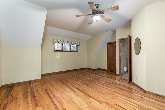 additional living space with ceiling fan, lofted ceiling, and light wood-type flooring