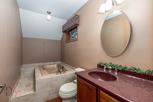 bathroom featuring a bathtub, vanity, lofted ceiling, tile patterned floors, and toilet