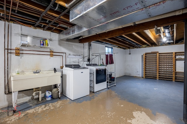 basement with washing machine and dryer and sink