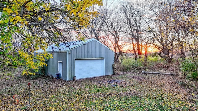 view of garage at dusk