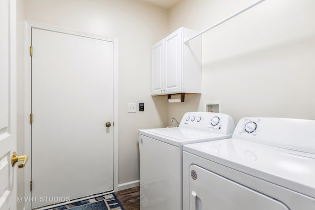 laundry area featuring cabinets, washing machine and dryer, and dark wood-type flooring