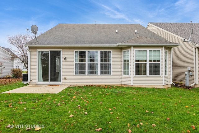 back of property with central AC, a yard, and a patio