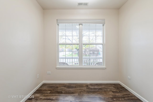 unfurnished room with dark hardwood / wood-style flooring