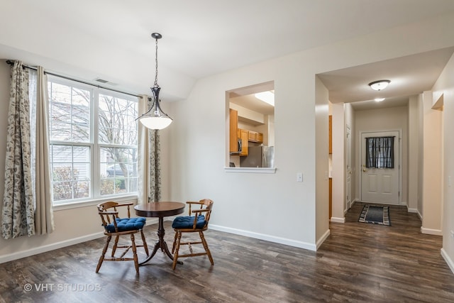 dining space with dark hardwood / wood-style flooring