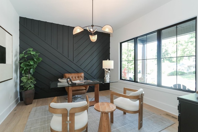 sitting room with a wealth of natural light and light hardwood / wood-style flooring