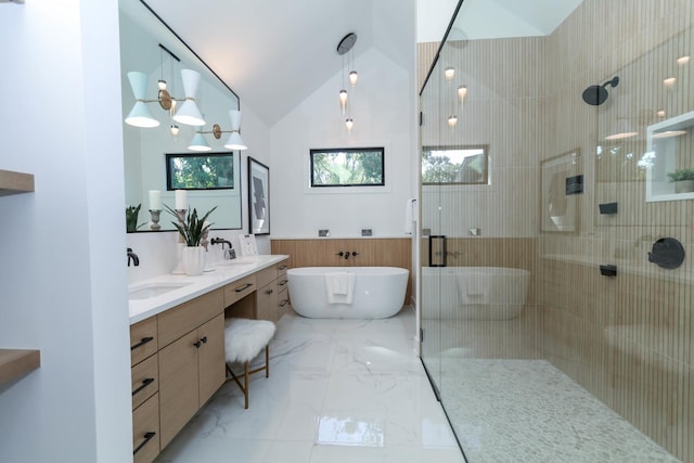 bathroom featuring vanity, vaulted ceiling, and independent shower and bath