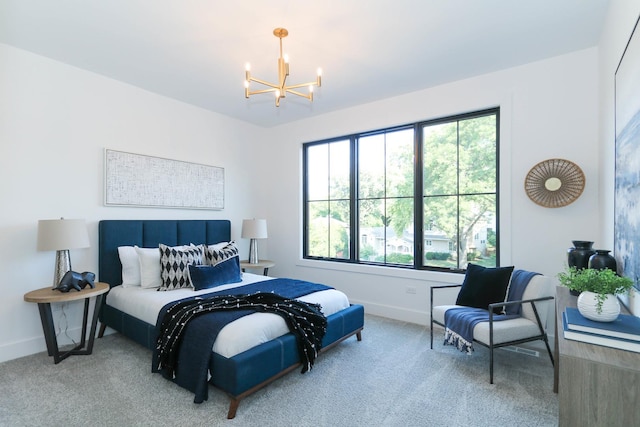 carpeted bedroom with an inviting chandelier