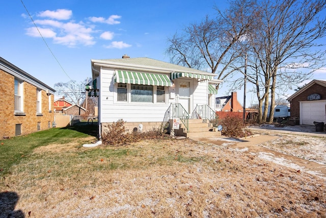 bungalow-style house with a front lawn