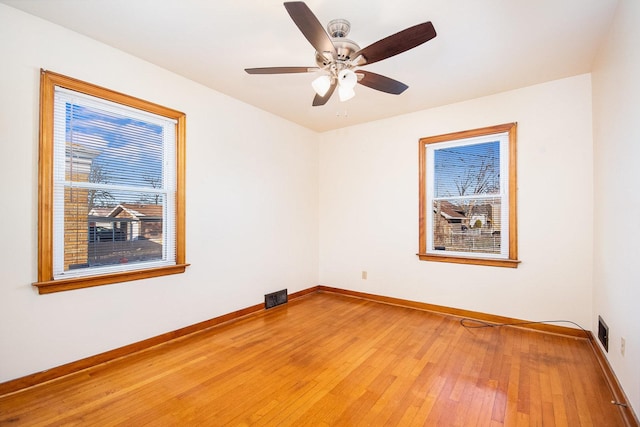 empty room with ceiling fan and wood-type flooring